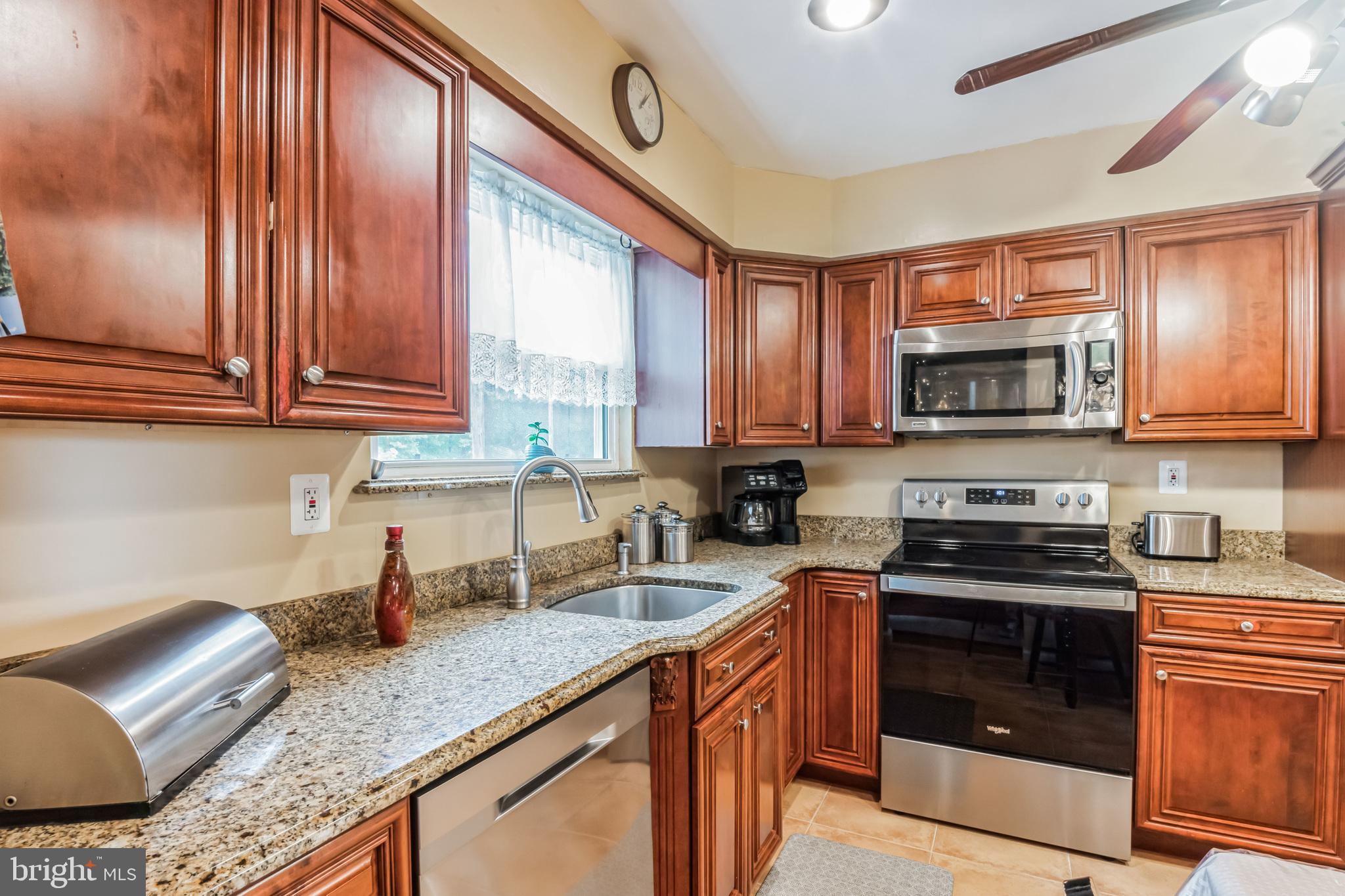 219 Forked Neck Road Shamong, NJ 08088 - Photo 9 of 26 a kitchen with stainless steel appliances granite countertop a stove a sink and a microwave