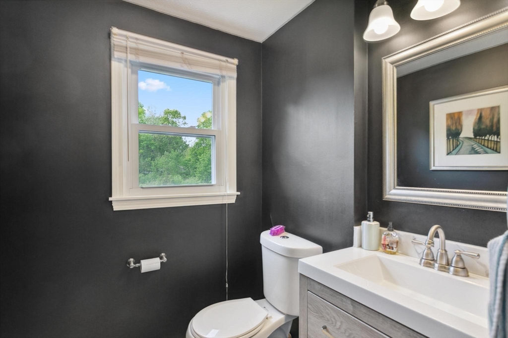 164 Nashua Road Pepperell, MA 01463 - Photo 11 of 28 a bathroom with a toilet a sink and a mirror