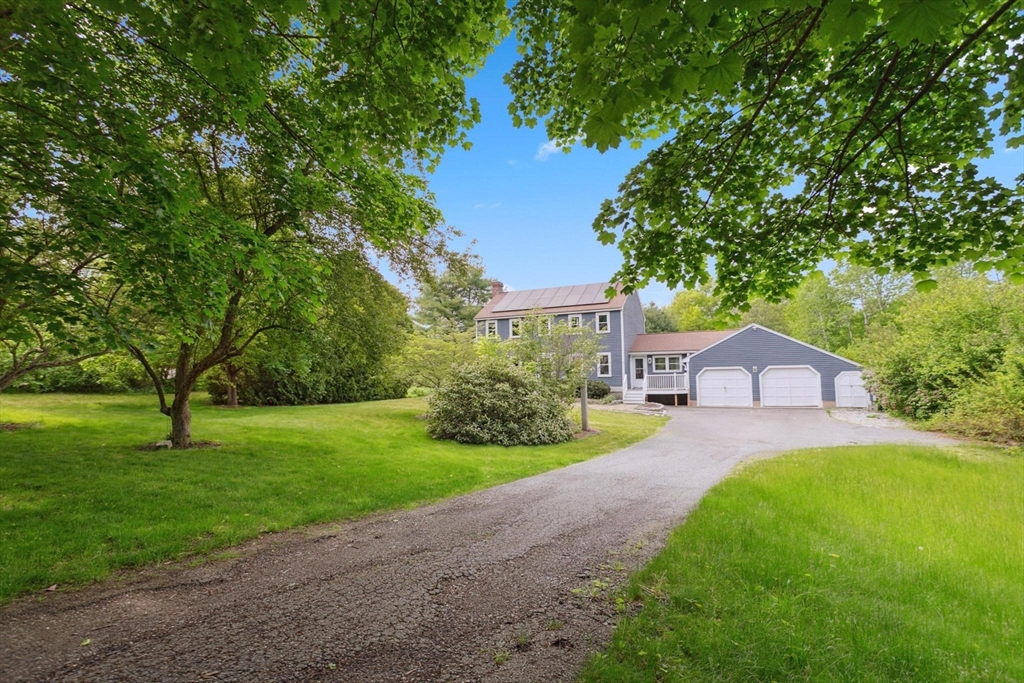 164 Nashua Road Pepperell, MA 01463 - Photo 2 of 28 a front view of a house with a yard and garage