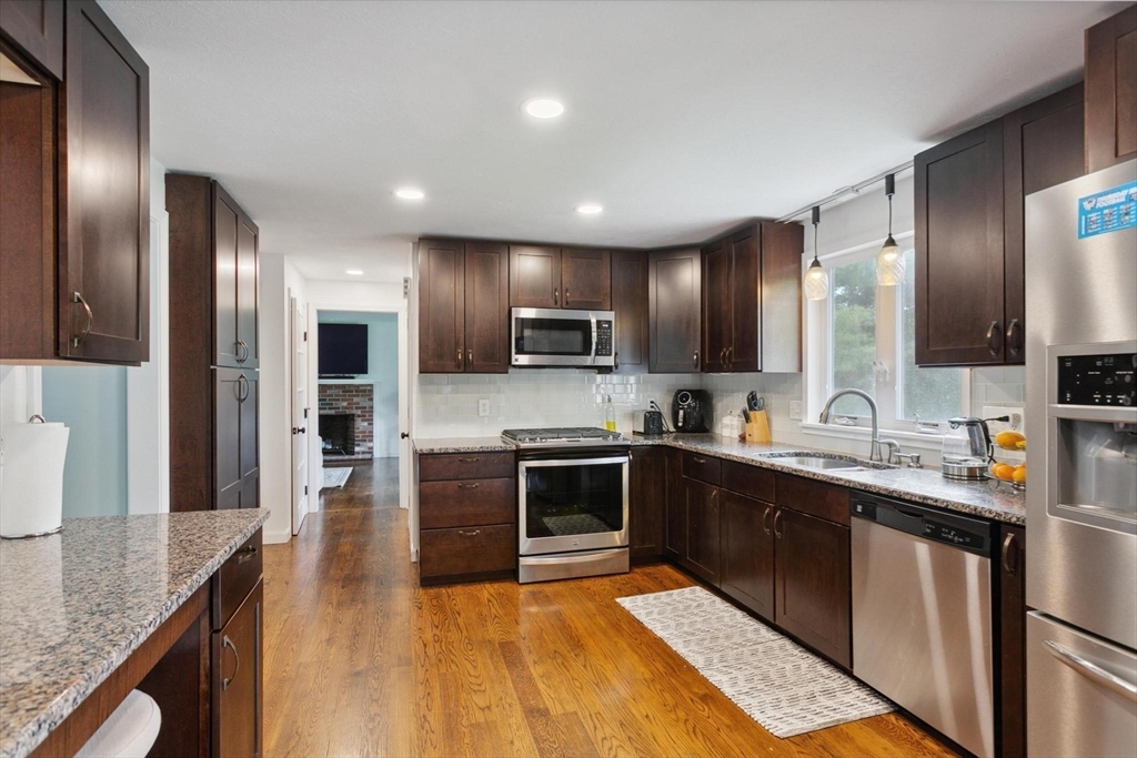 164 Nashua Road Pepperell, MA 01463 - Photo 6 of 28 a large kitchen with stainless steel appliances granite countertop a sink and a stove
