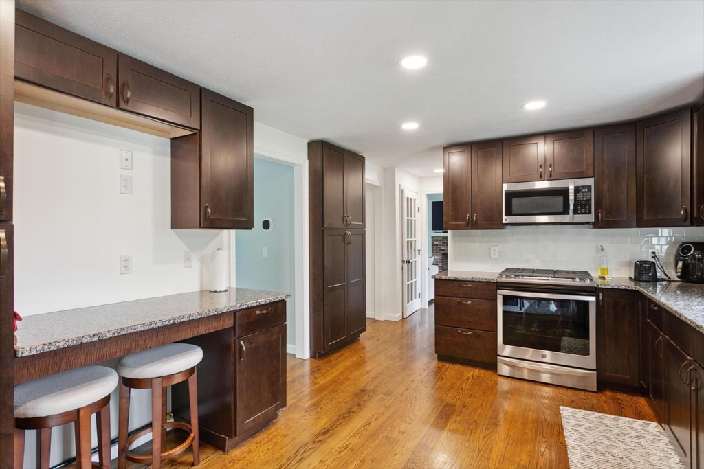 164 Nashua Road Pepperell, MA 01463 - Photo 7 of 28 a kitchen with stainless steel appliances granite countertop a stove a sink and a microwave