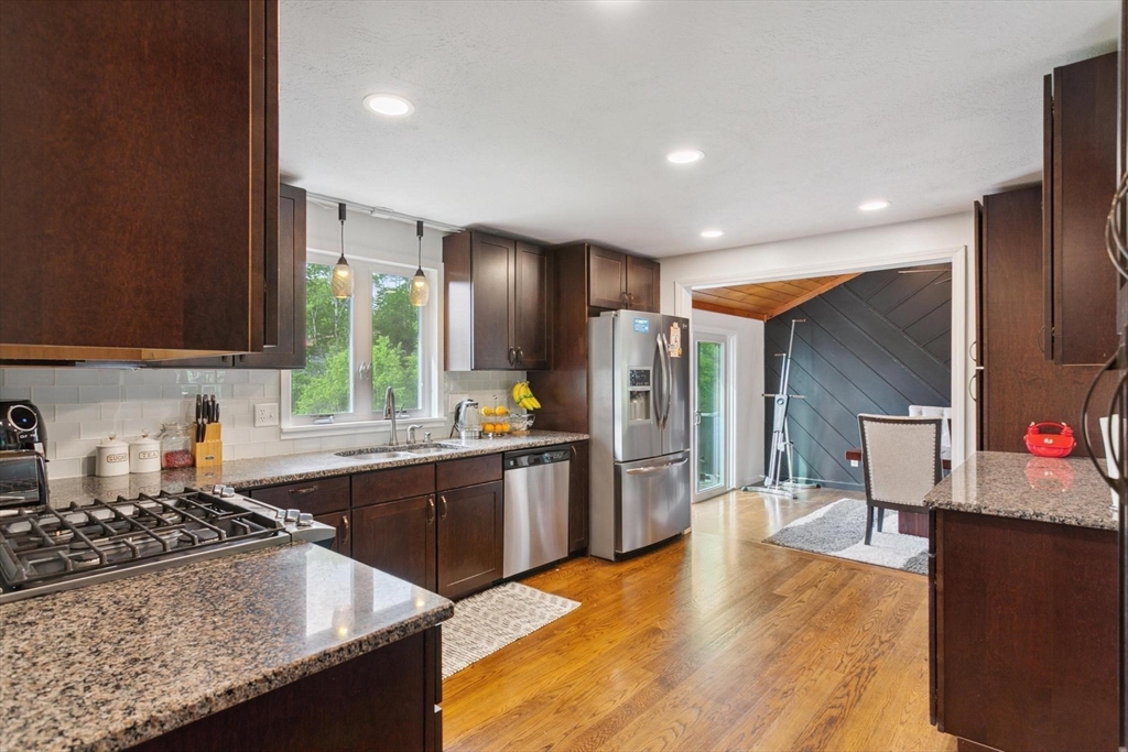 164 Nashua Road Pepperell, MA 01463 - Photo 8 of 28 a kitchen with stainless steel appliances granite countertop a sink stove and refrigerator