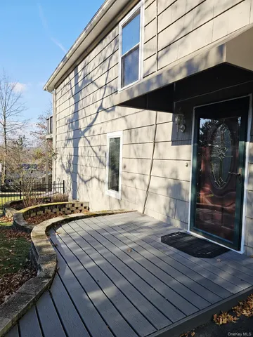 a view of a balcony with wooden floor