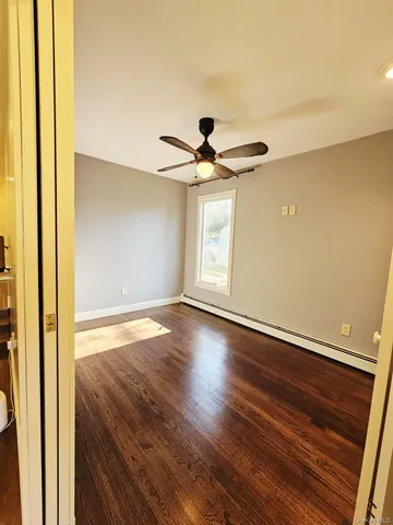 wooden floor in an empty room with a window