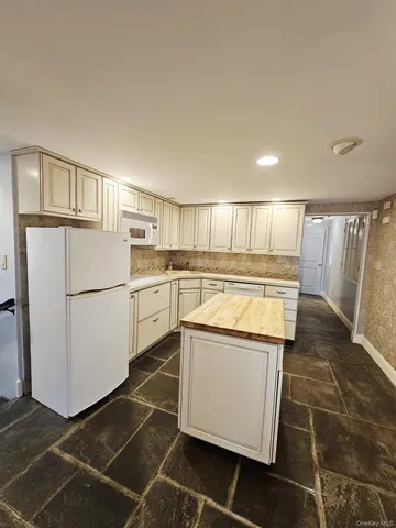 a kitchen with wooden cabinets and white appliances
