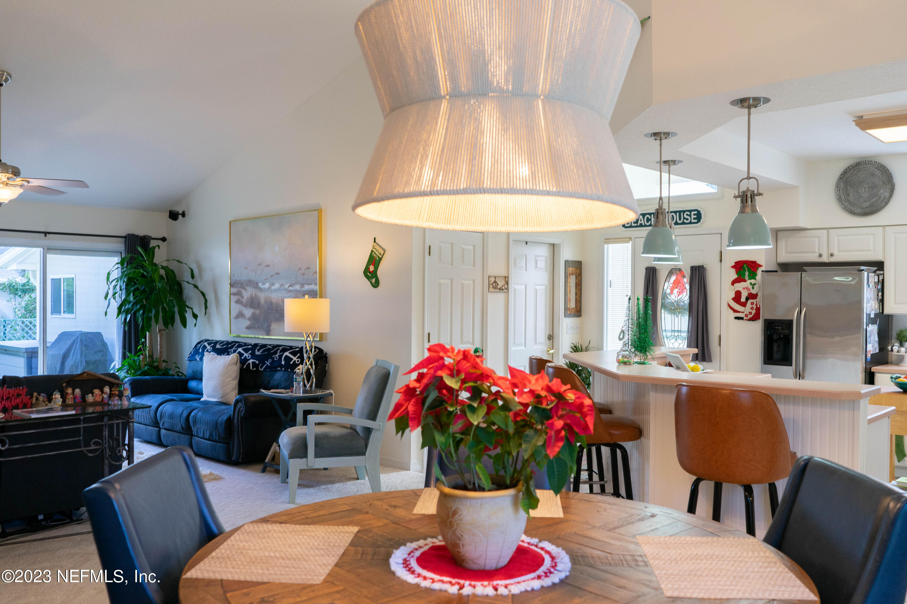950-952 Irma Way St. Augustine, FL 32086 - Photo 13 of 40 a dining room with furniture potted plants and wooden floor