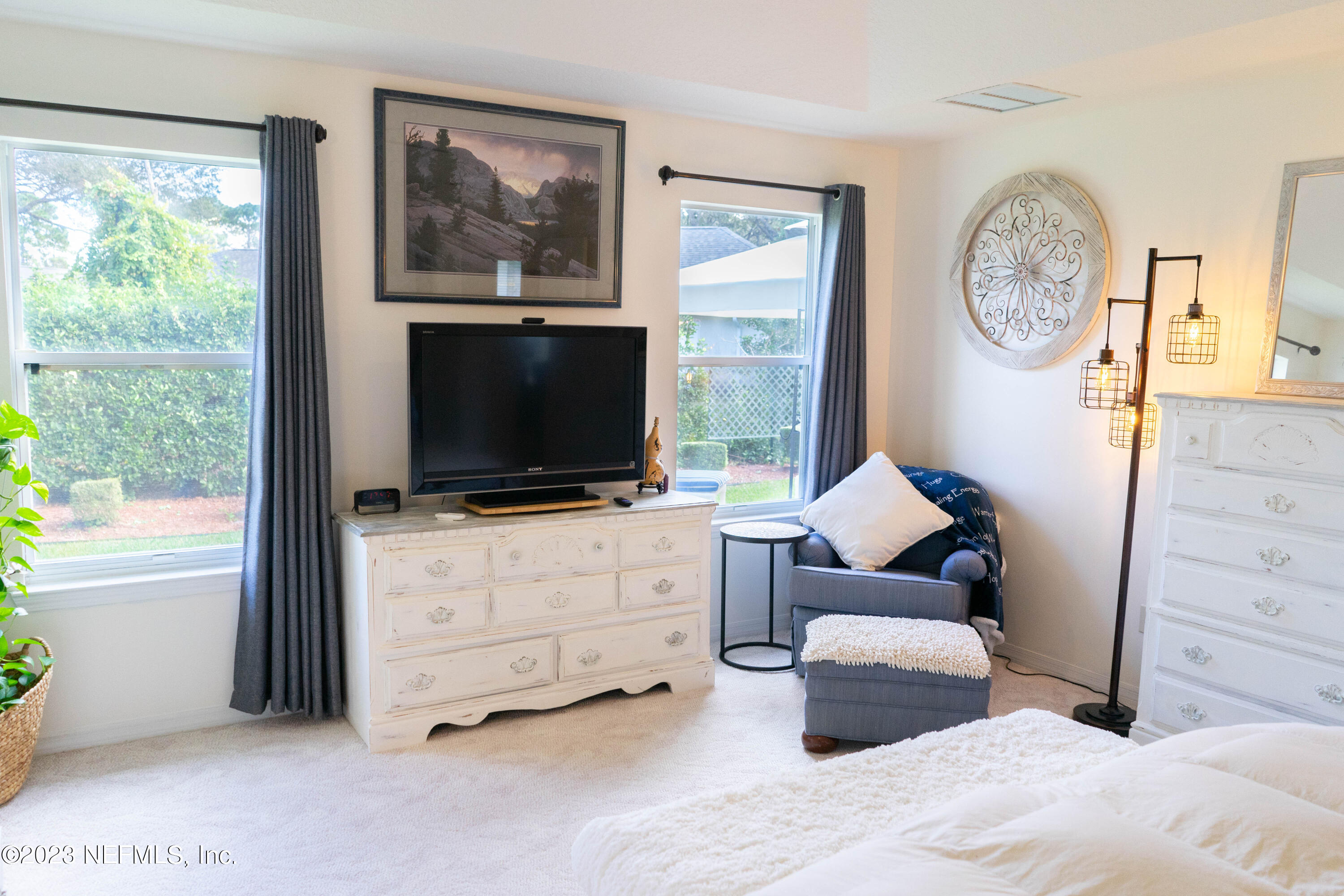 950-952 Irma Way St. Augustine, FL 32086 - Photo 18 of 40 a living room with furniture a flat screen tv and a window