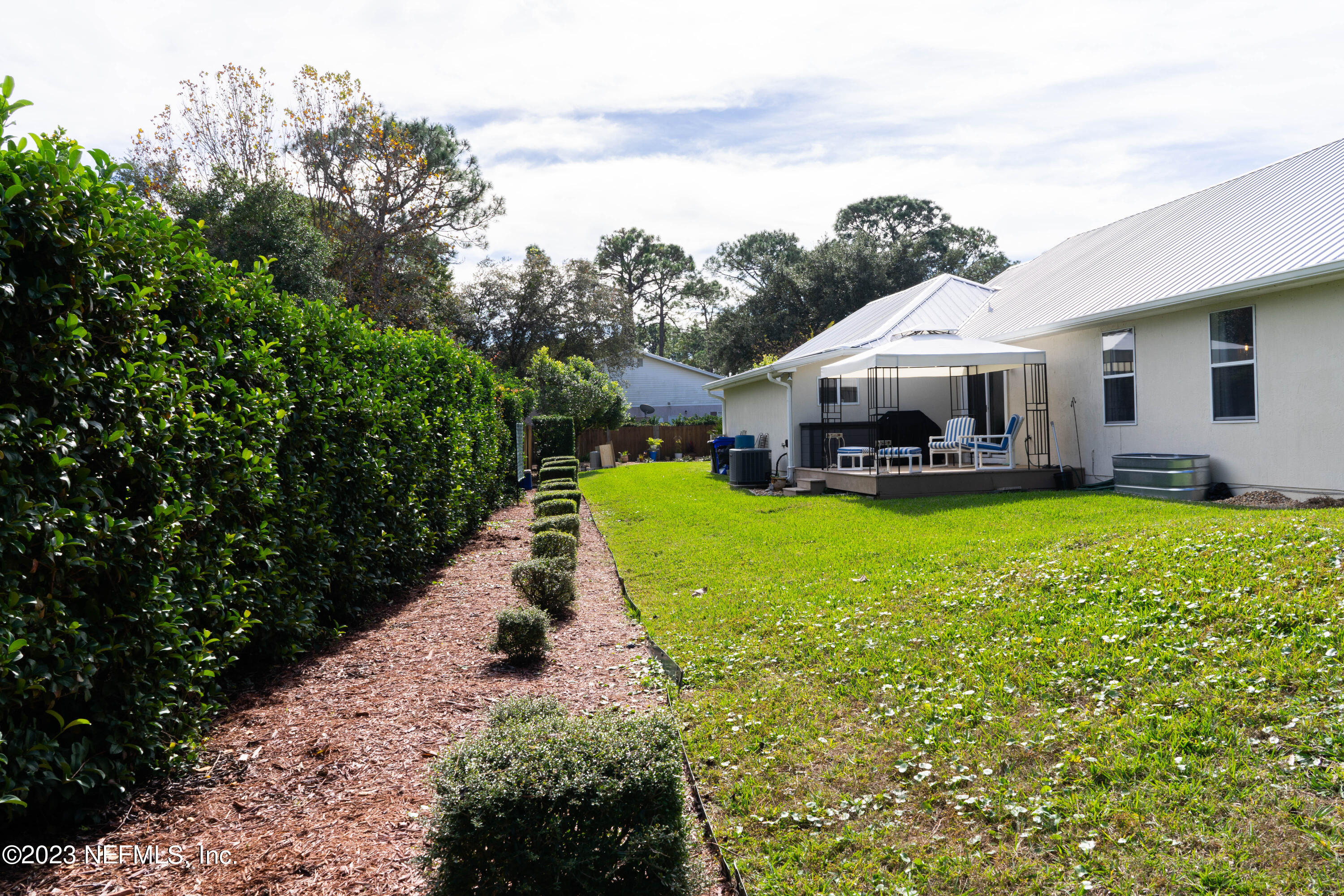 950-952 Irma Way St. Augustine, FL 32086 - Photo 30 of 40 a view of a house with a yard porch and sitting area