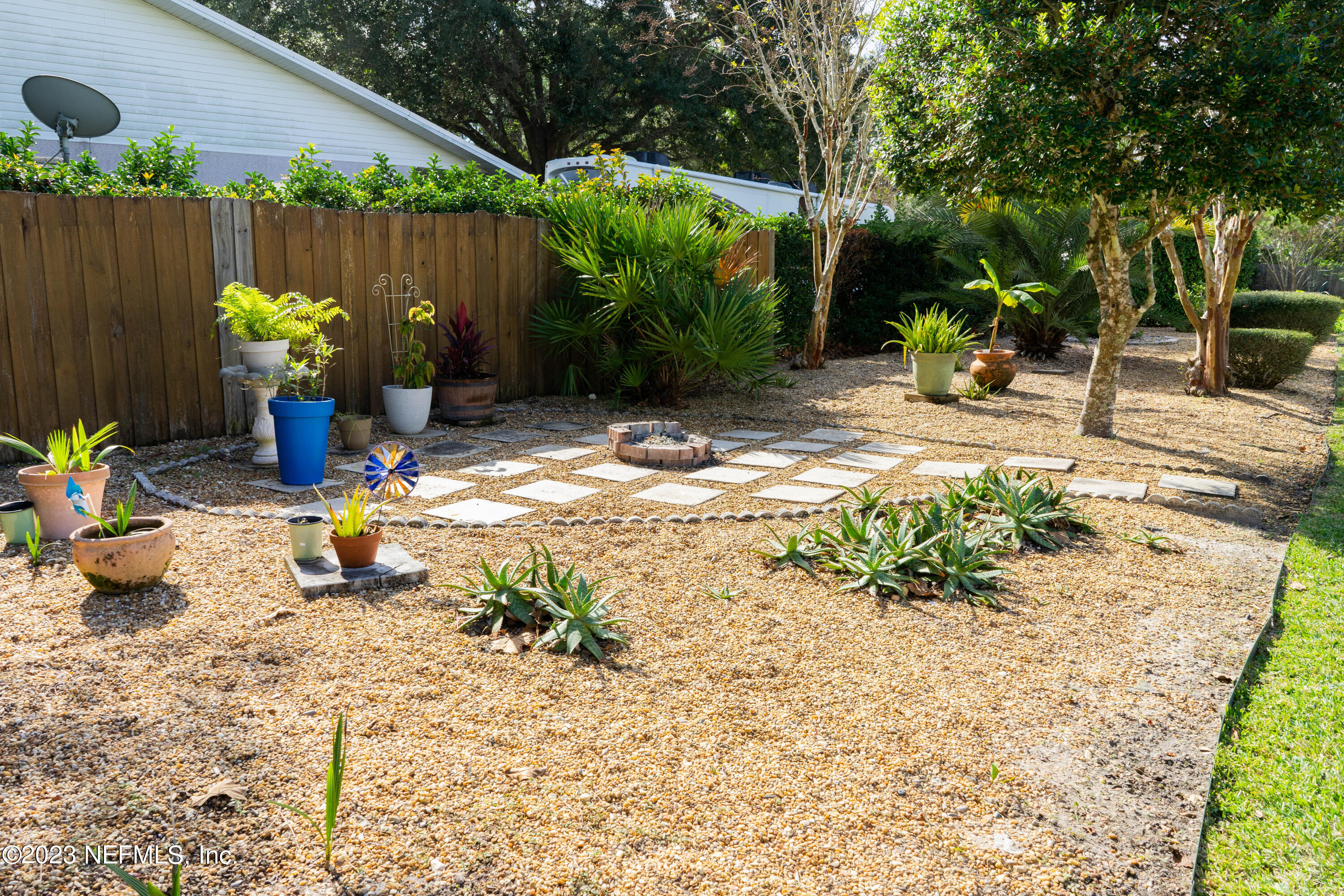 950-952 Irma Way St. Augustine, FL 32086 - Photo 38 of 40 a view of a backyard with plants and chairs