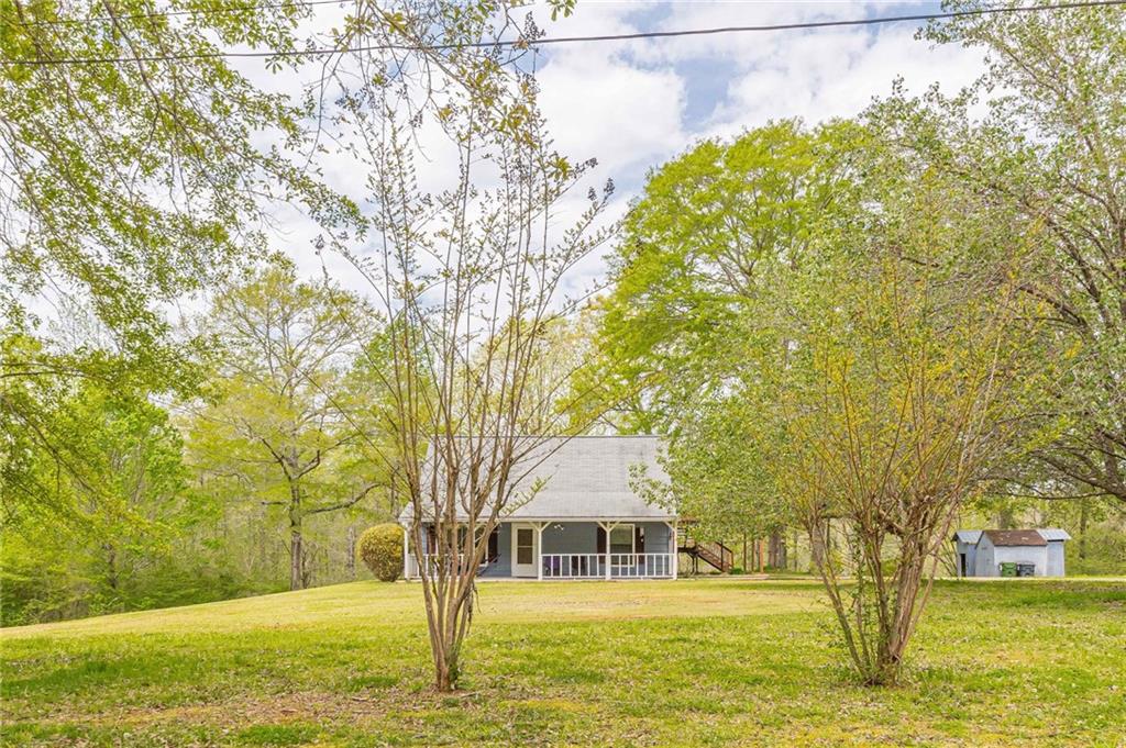 4242 South River Road Franklin, GA 30217 - Photo 1 of 1 a view of a house with garden and trees