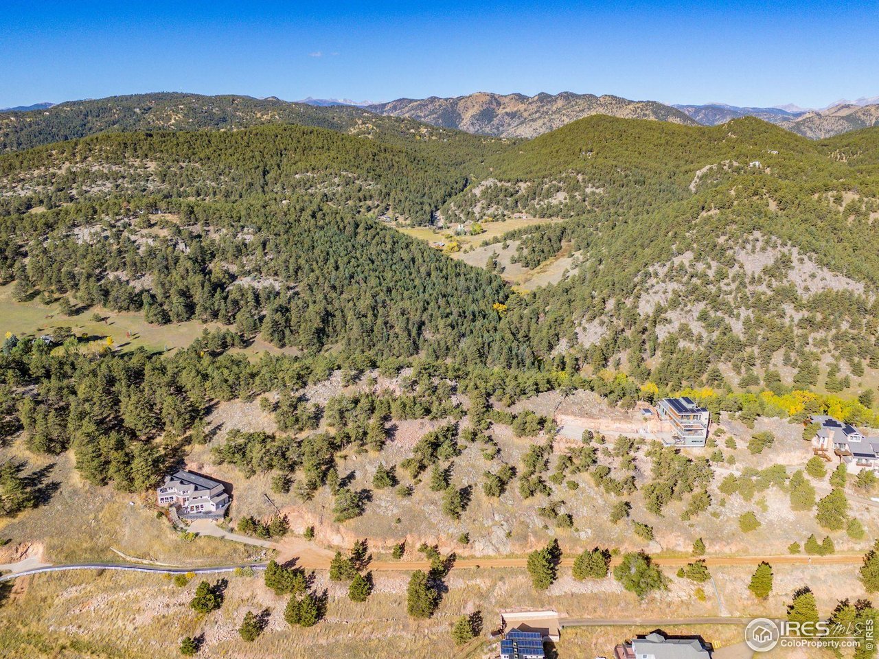 6109 Red Hill Road Boulder, CO 80302 - Photo 20 of 22 a view of a lush green hillside and houses