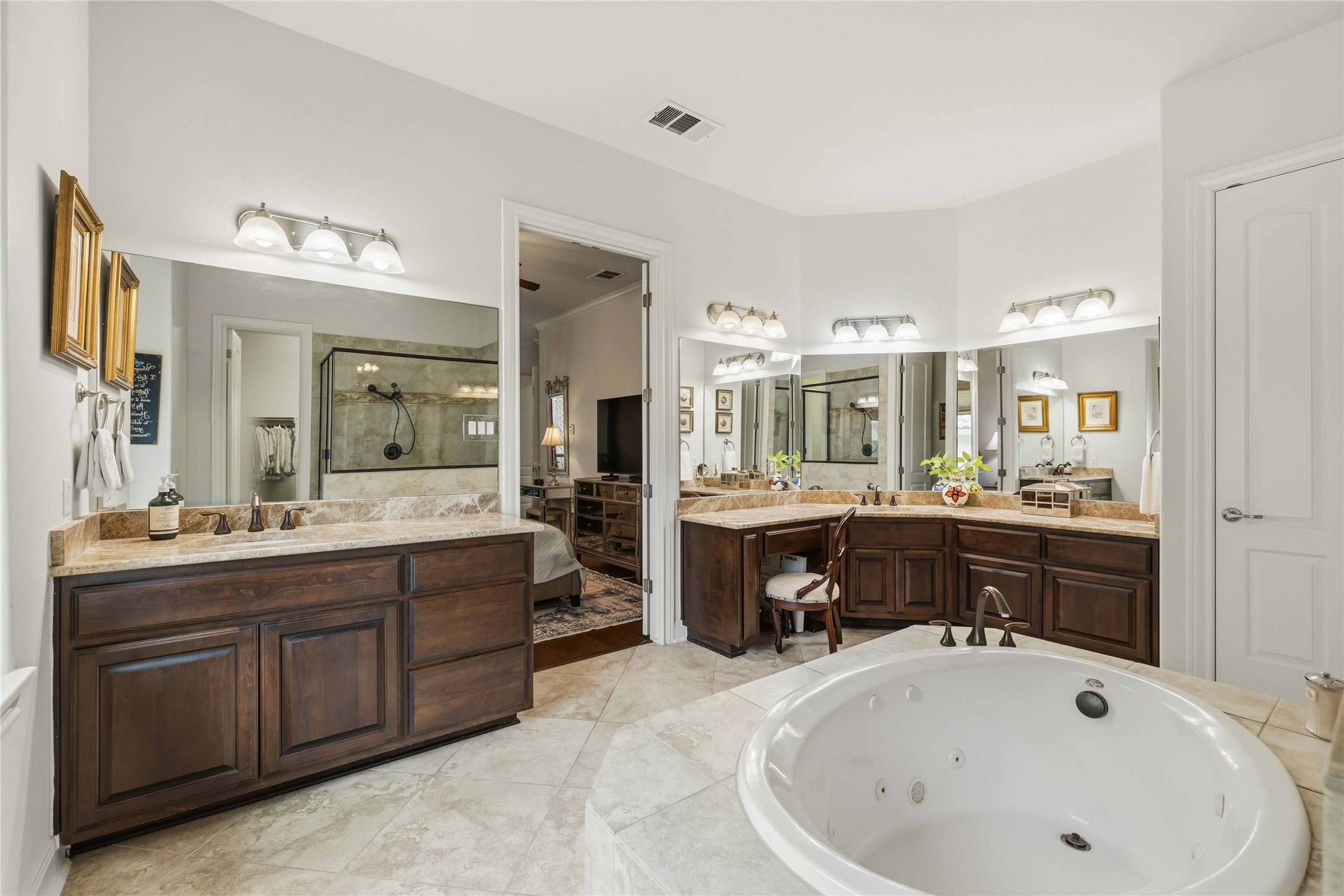 15200 Spillman Ranch Loop Austin, TX 78738 - Photo 19 of 40 This bathroom features a large soaking tub, dual vanity with undermount sinks, and a separate shower enclosure with a glass door