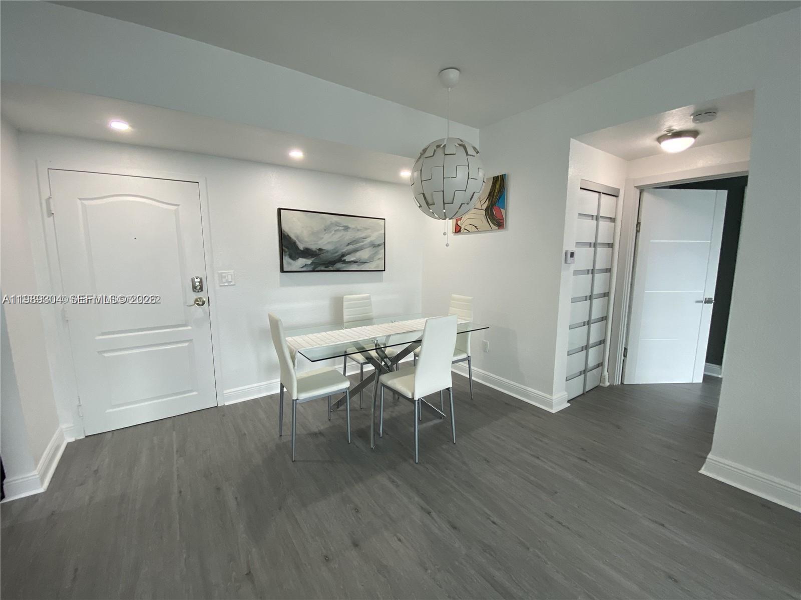 500 Northeast 29th Street, Unit 608 Miami, FL 33137 - Photo 13 of 36 a view of a dining room with furniture and wooden floor