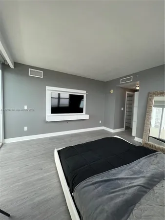 a living room with a flat screen tv and window