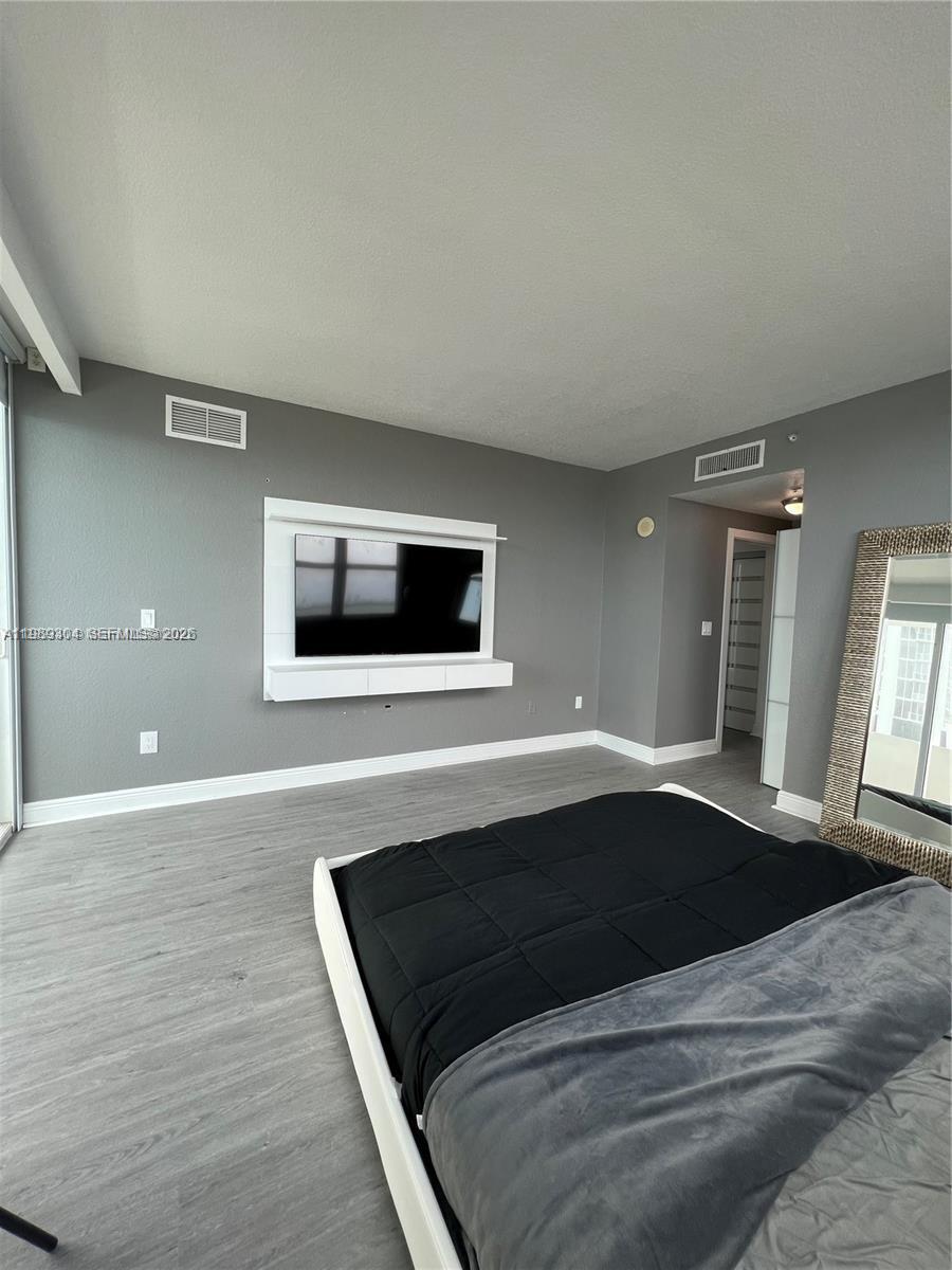 500 Northeast 29th Street, Unit 608 Miami, FL 33137 - Photo 15 of 36 a living room with a flat screen tv and window