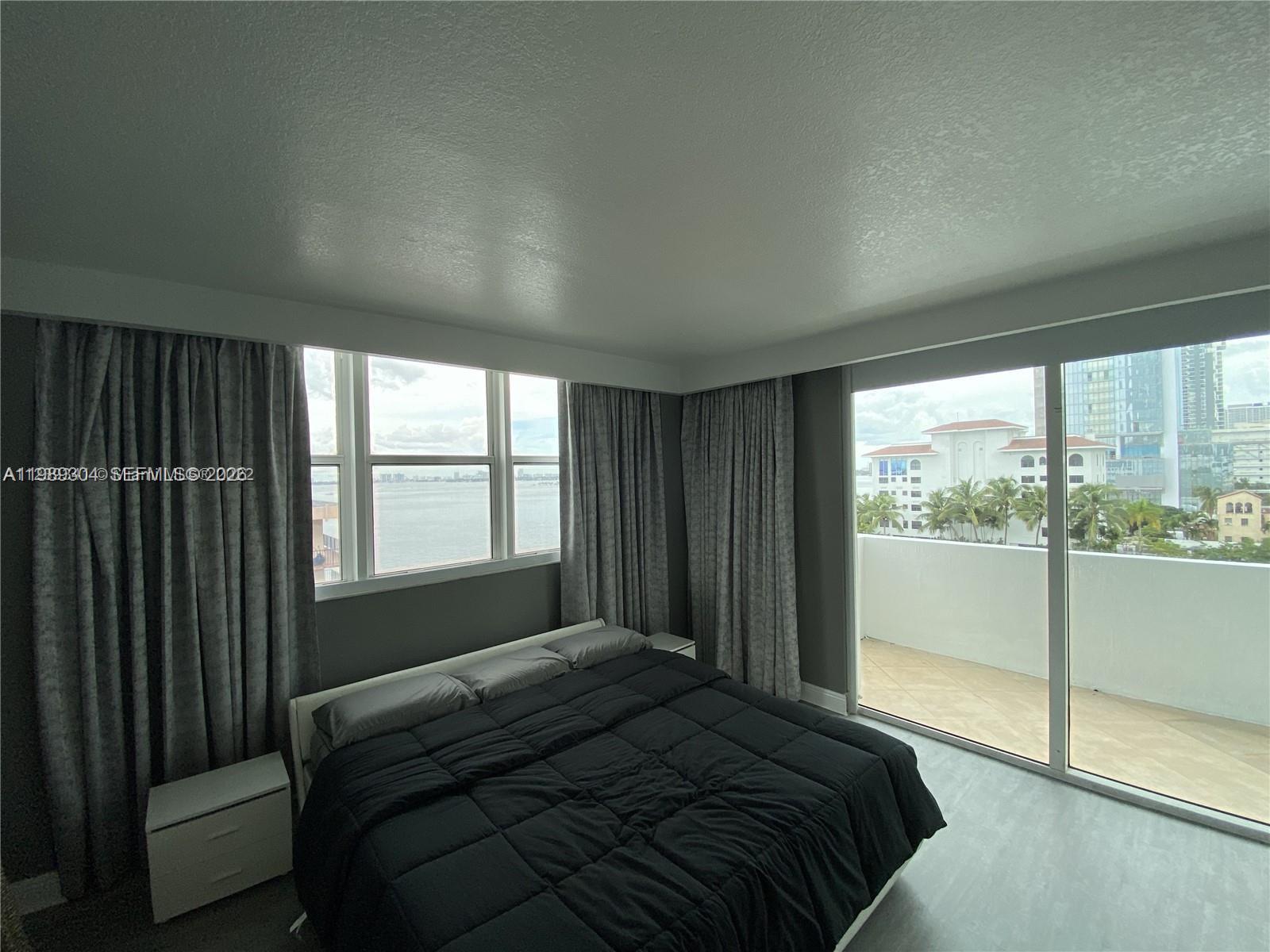 500 Northeast 29th Street, Unit 608 Miami, FL 33137 - Photo 17 of 36 a bedroom with a bed and a window