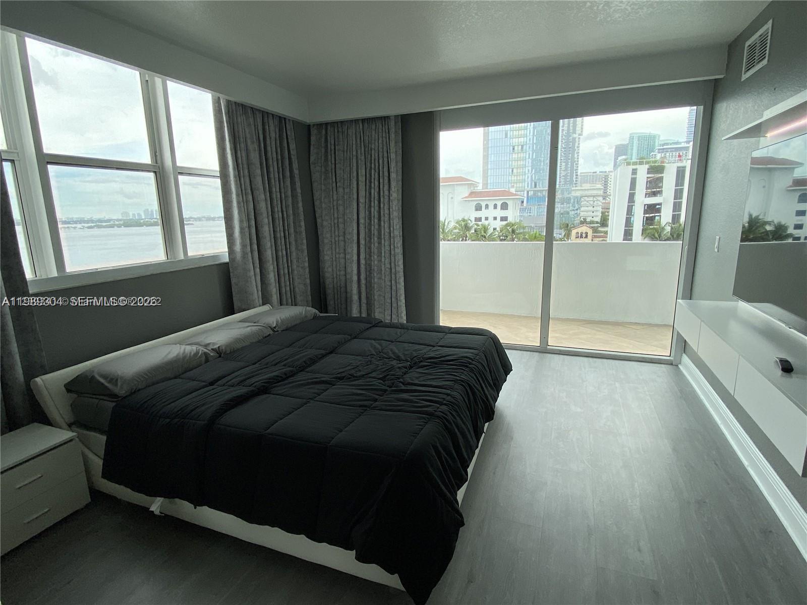 500 Northeast 29th Street, Unit 608 Miami, FL 33137 - Photo 18 of 36 a bedroom with a bed and large window