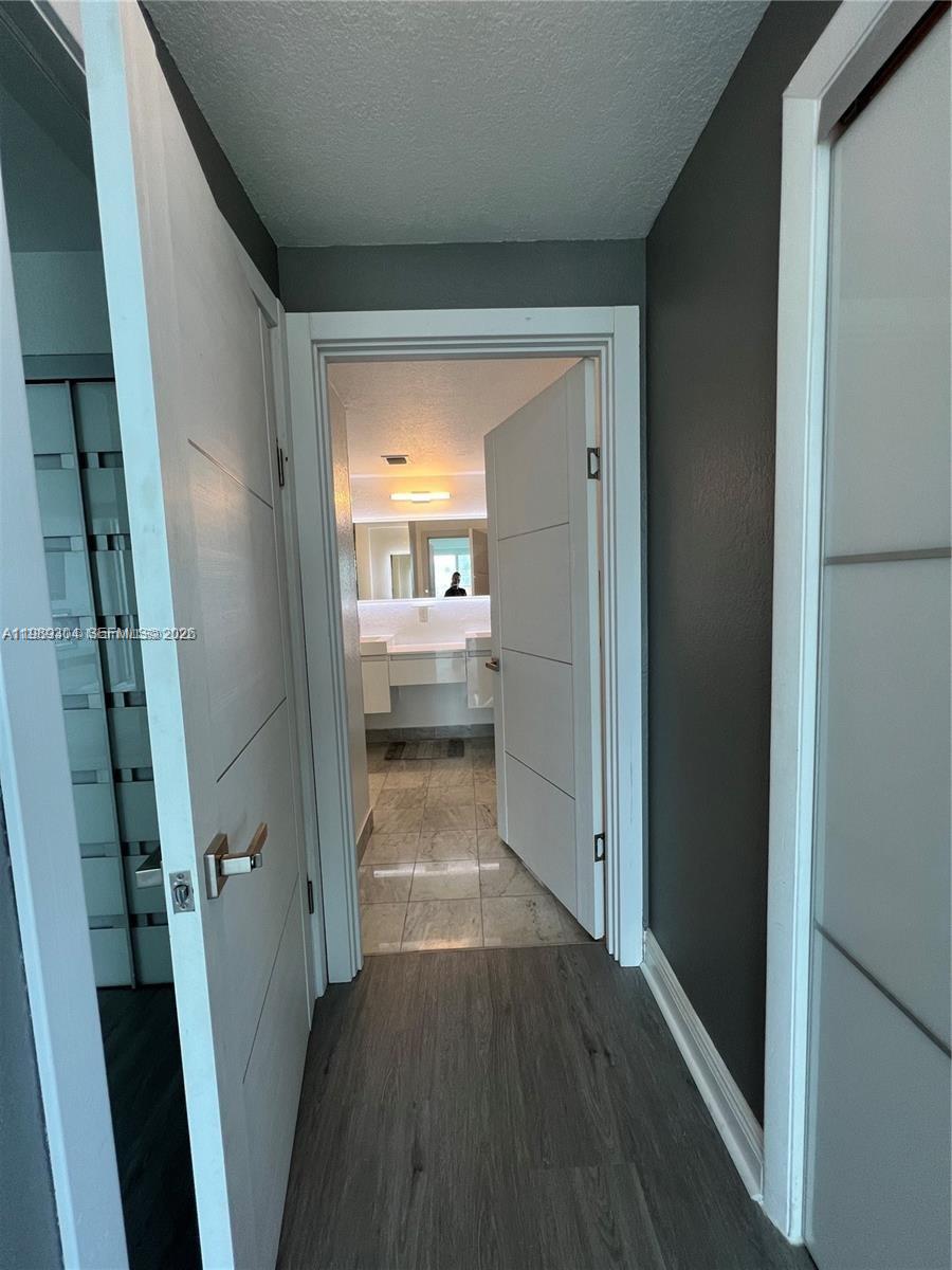500 Northeast 29th Street, Unit 608 Miami, FL 33137 - Photo 21 of 36 a view of a hallway with wooden floor and a living room