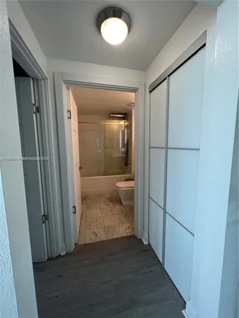 a view of a hallway with wooden floor