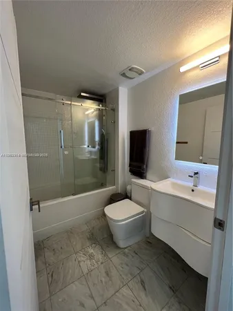 a bathroom with a toilet a sink and bathtub