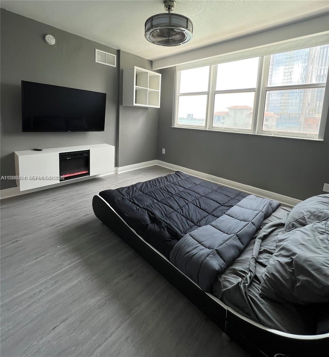 500 Northeast 29th Street, Unit 608 Miami, FL 33137 - Photo 25 of 36 a living room with furniture and a flat screen tv