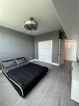 a bed sitting in a room next to a window