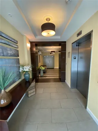 a lobby with furniture and a potted plant