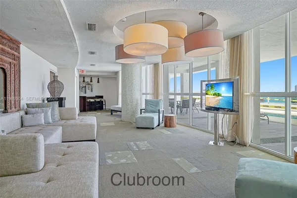 a living room with furniture and a chandelier
