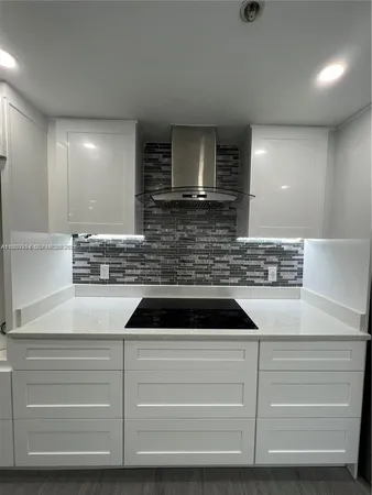 a kitchen with cabinets appliances and a counter top space
