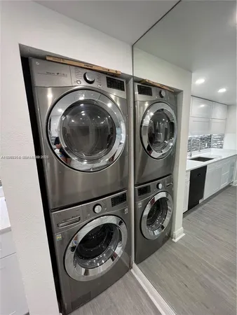 a utility room with sink dryer and washer
