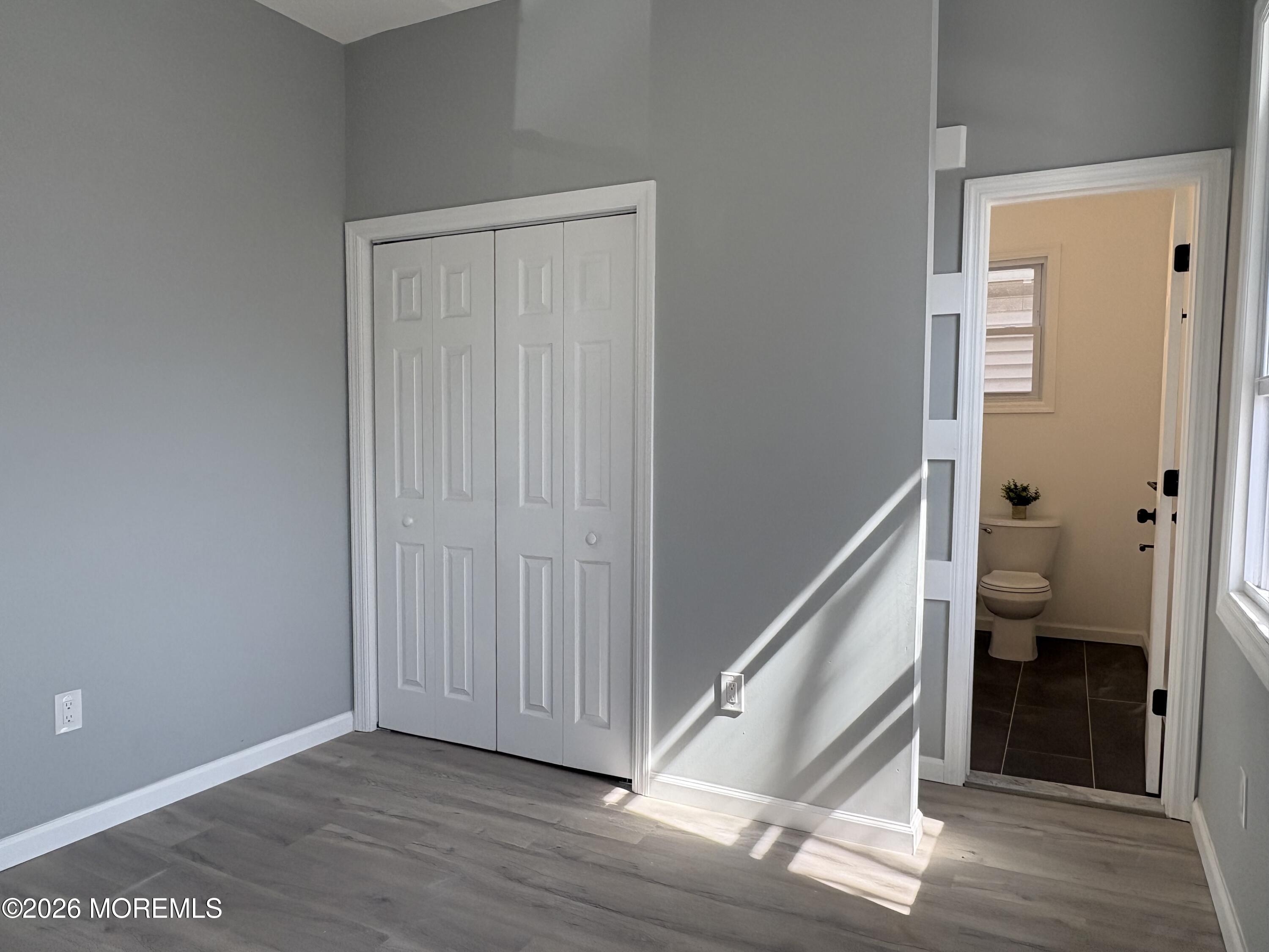 456 Harrison Street, Unit 2 Passaic, NJ 07055 - Photo 12 of 15 a view of a hallway with bathroom and wooden floor