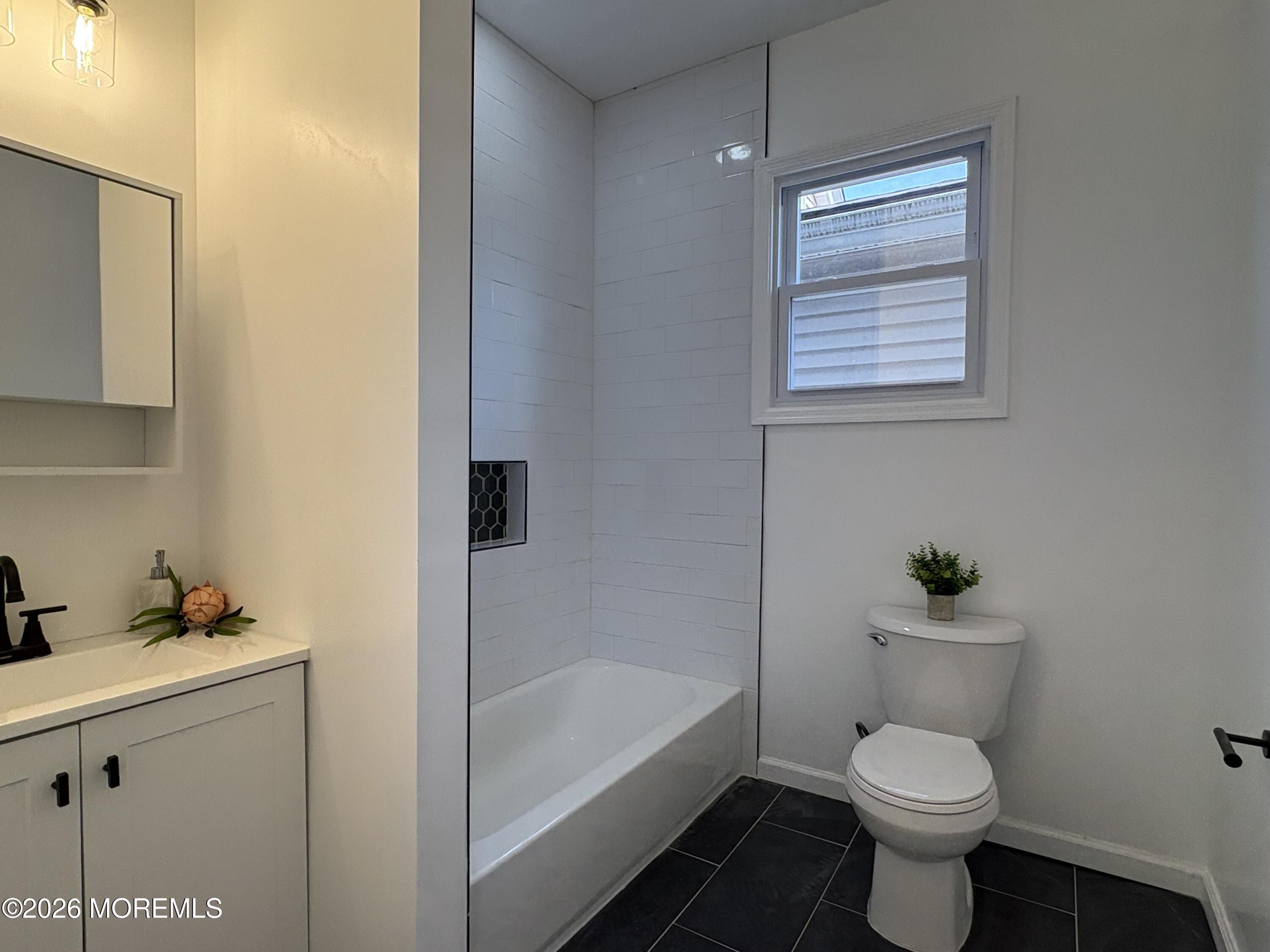 456 Harrison Street, Unit 2 Passaic, NJ 07055 - Photo 13 of 15 a bathroom with a toilet a sink and bathtub