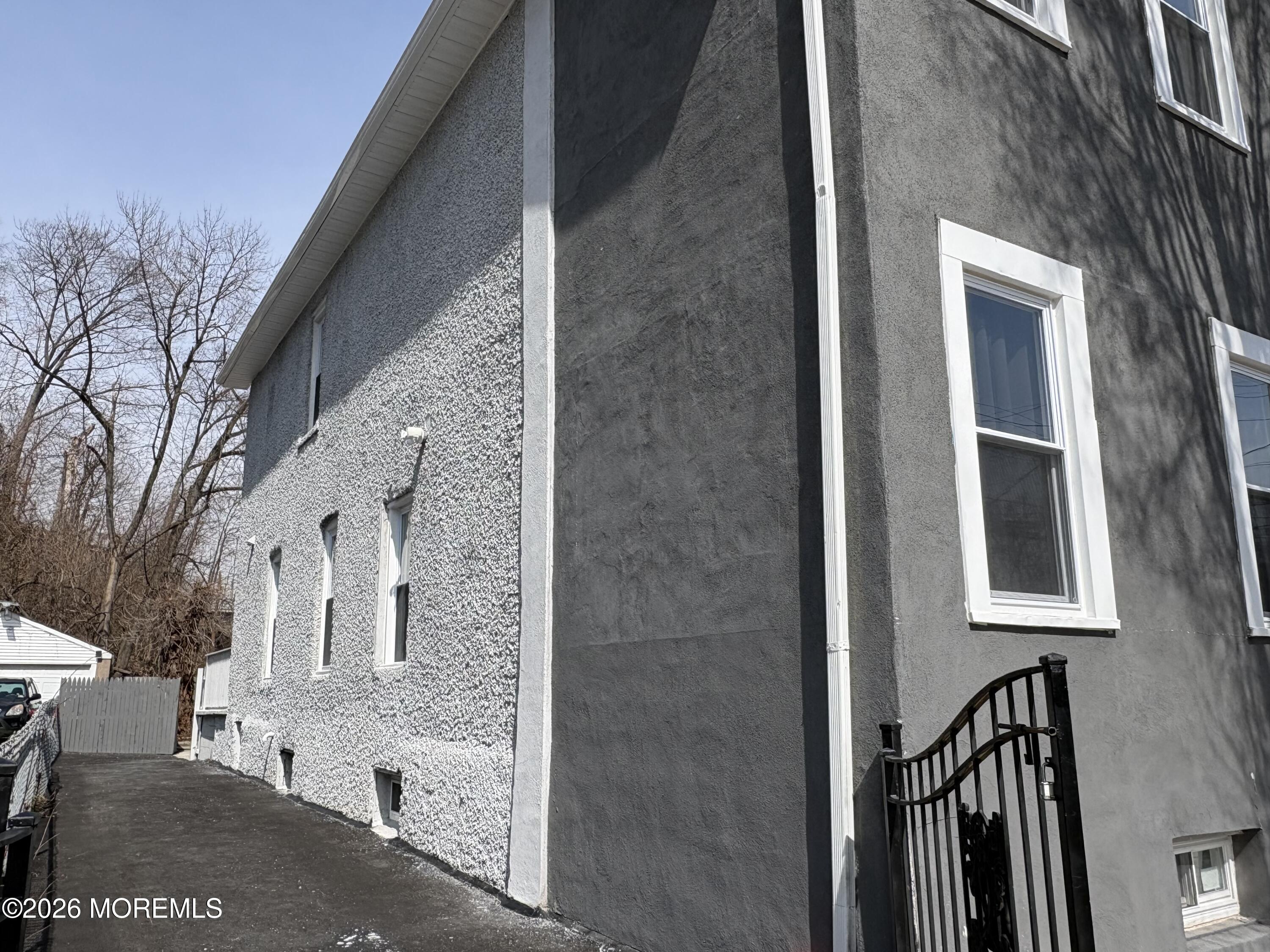 456 Harrison Street, Unit 2 Passaic, NJ 07055 - Photo 15 of 15 a view of a grey house with a yard