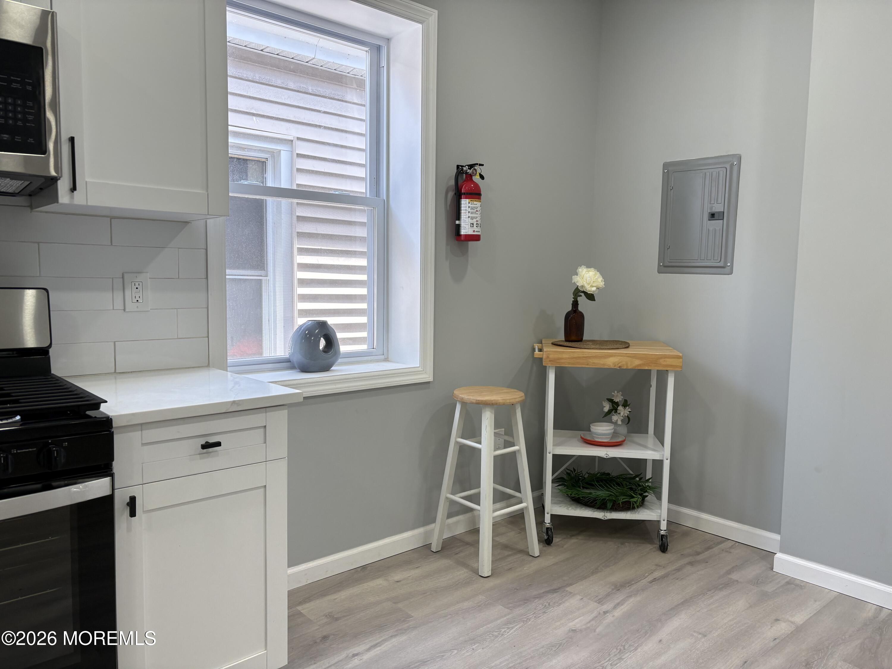 456 Harrison Street, Unit 2 Passaic, NJ 07055 - Photo 8 of 15 a kitchen with a chair and cabinets