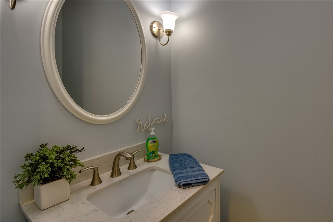 206 Petty Road Seneca, SC 29672 - Photo 18 of 48 A pristine powder room vanity with polished brass fixtures and a clean, bright basin.