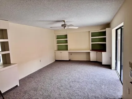 an empty room with a cabinet and mirrors