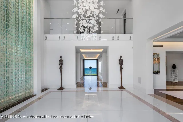 a large white kitchen with kitchen island granite countertop a large counter top and sink