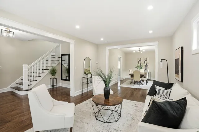 a living room with furniture a rug and a chandelier