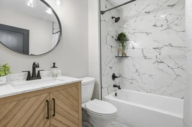 a bathroom with a sink a toilet and a mirror