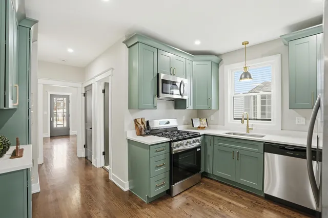 a kitchen with a sink stove and cabinets