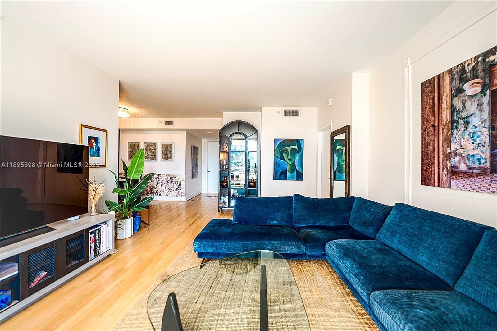 888 Brickell Key Drive, Unit 903 Miami, FL 33131 - Photo 1 of 38 a living room with furniture and a flat screen tv