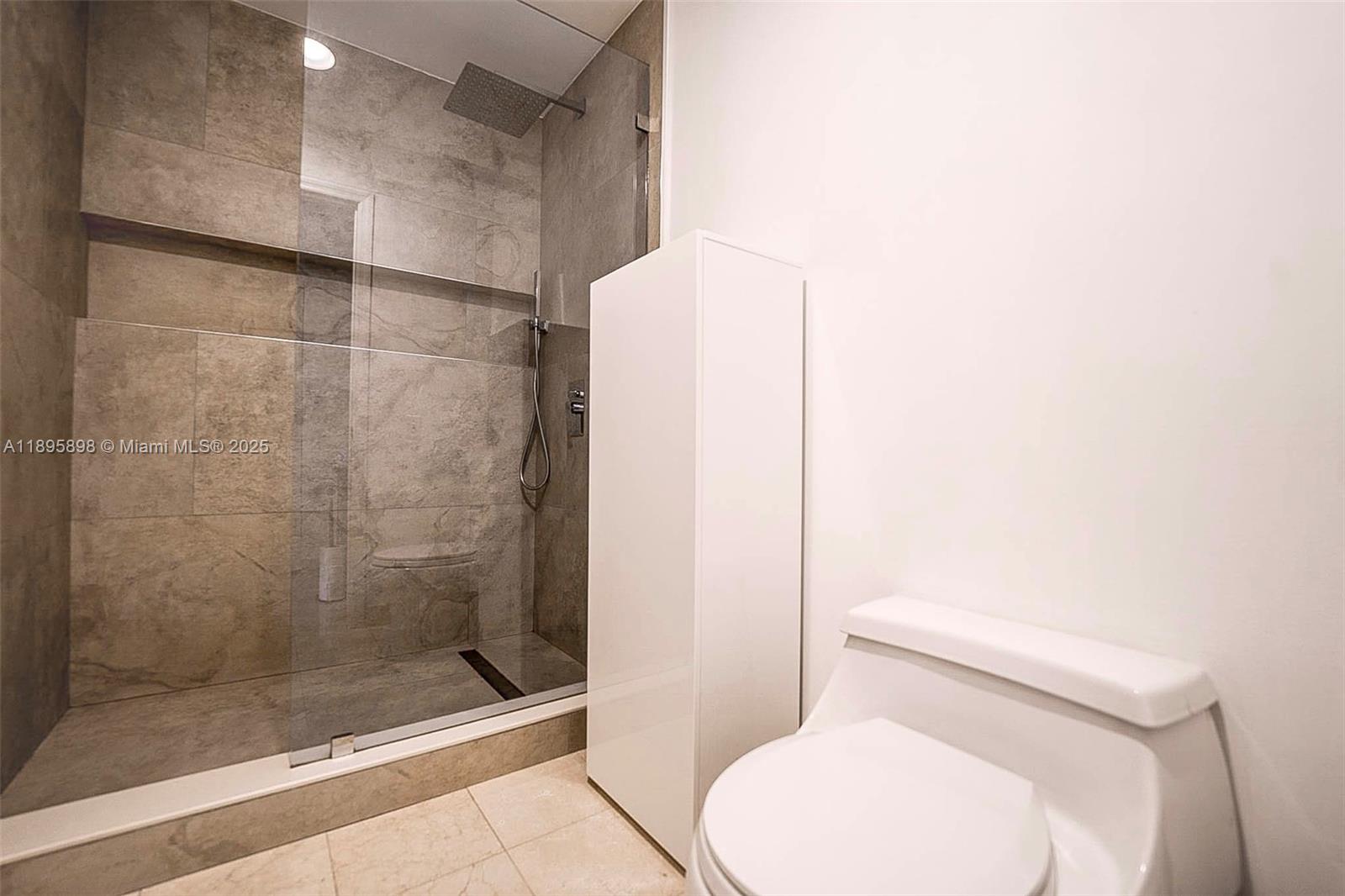 888 Brickell Key Drive, Unit 903 Miami, FL 33131 - Photo 13 of 38 a white toilet sitting next to a bath tub