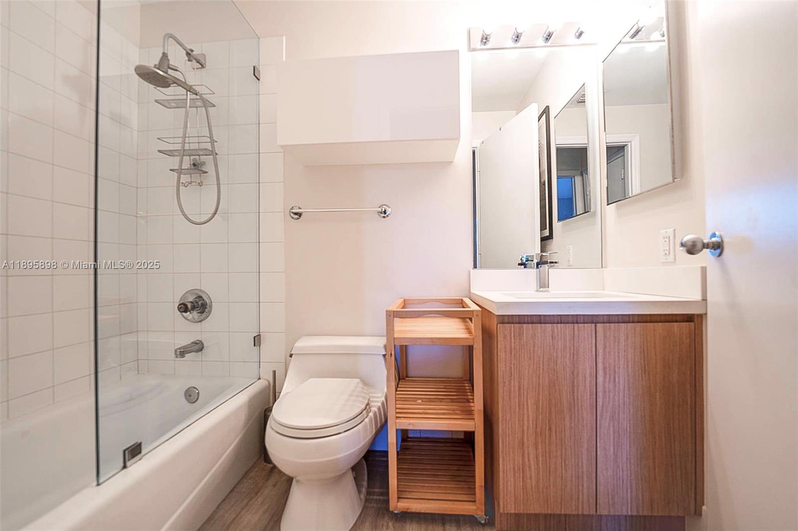 888 Brickell Key Drive, Unit 903 Miami, FL 33131 - Photo 16 of 38 a bathroom with a toilet sink vanity tub and shower