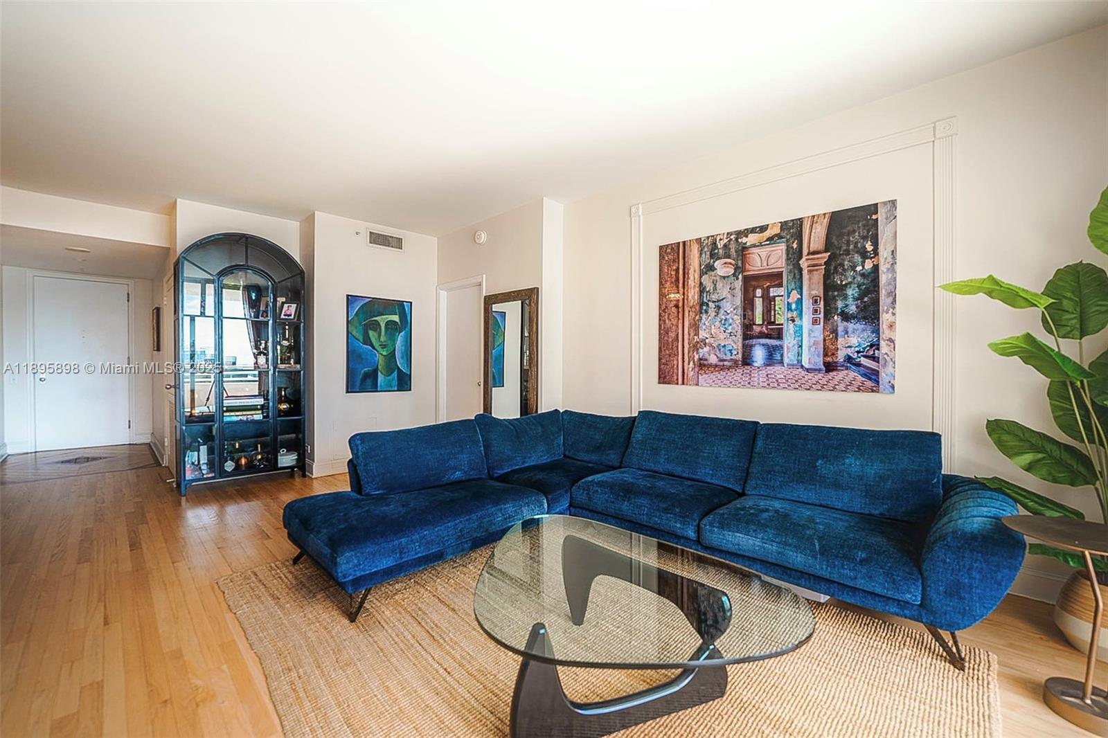 888 Brickell Key Drive, Unit 903 Miami, FL 33131 - Photo 2 of 38 a living room with furniture and a potted plant