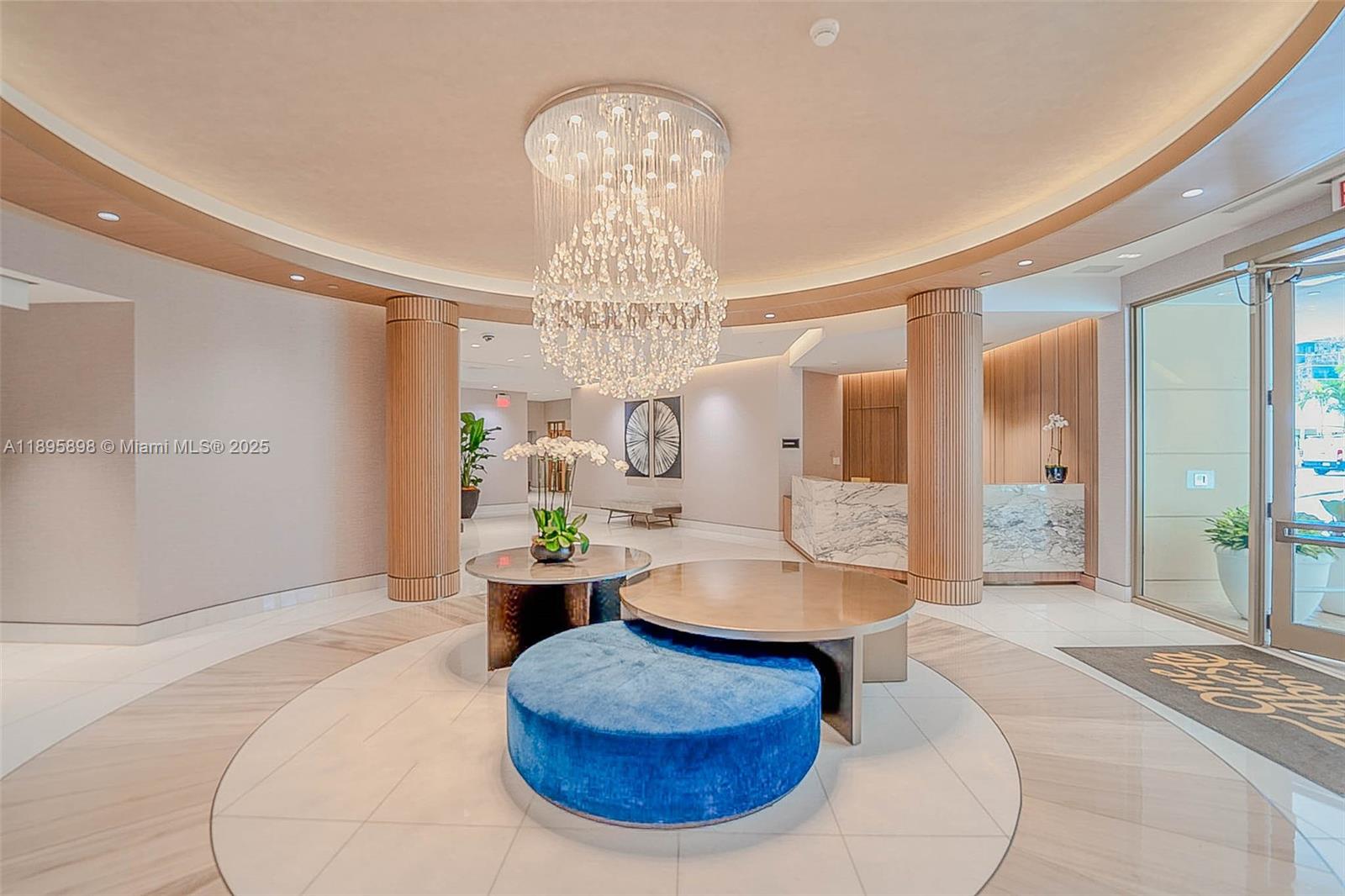 888 Brickell Key Drive, Unit 903 Miami, FL 33131 - Photo 23 of 38 a living room with furniture and a chandelier