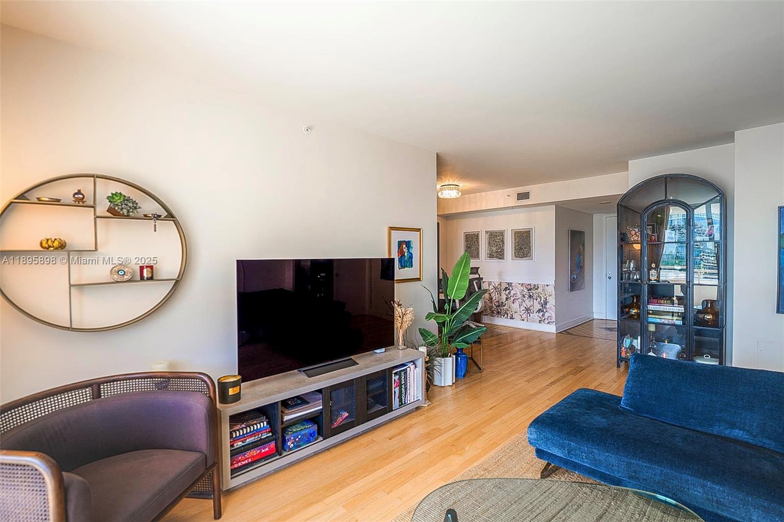 888 Brickell Key Drive, Unit 903 Miami, FL 33131 - Photo 3 of 38 a living room with furniture and a flat screen tv