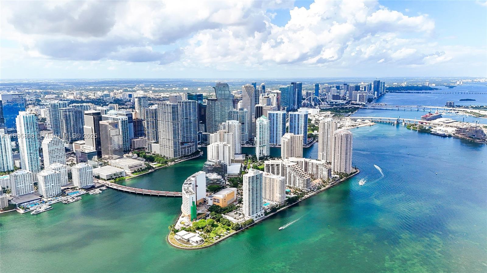 888 Brickell Key Drive, Unit 903 Miami, FL 33131 - Photo 35 of 38 a view of a lake with lawn chairs
