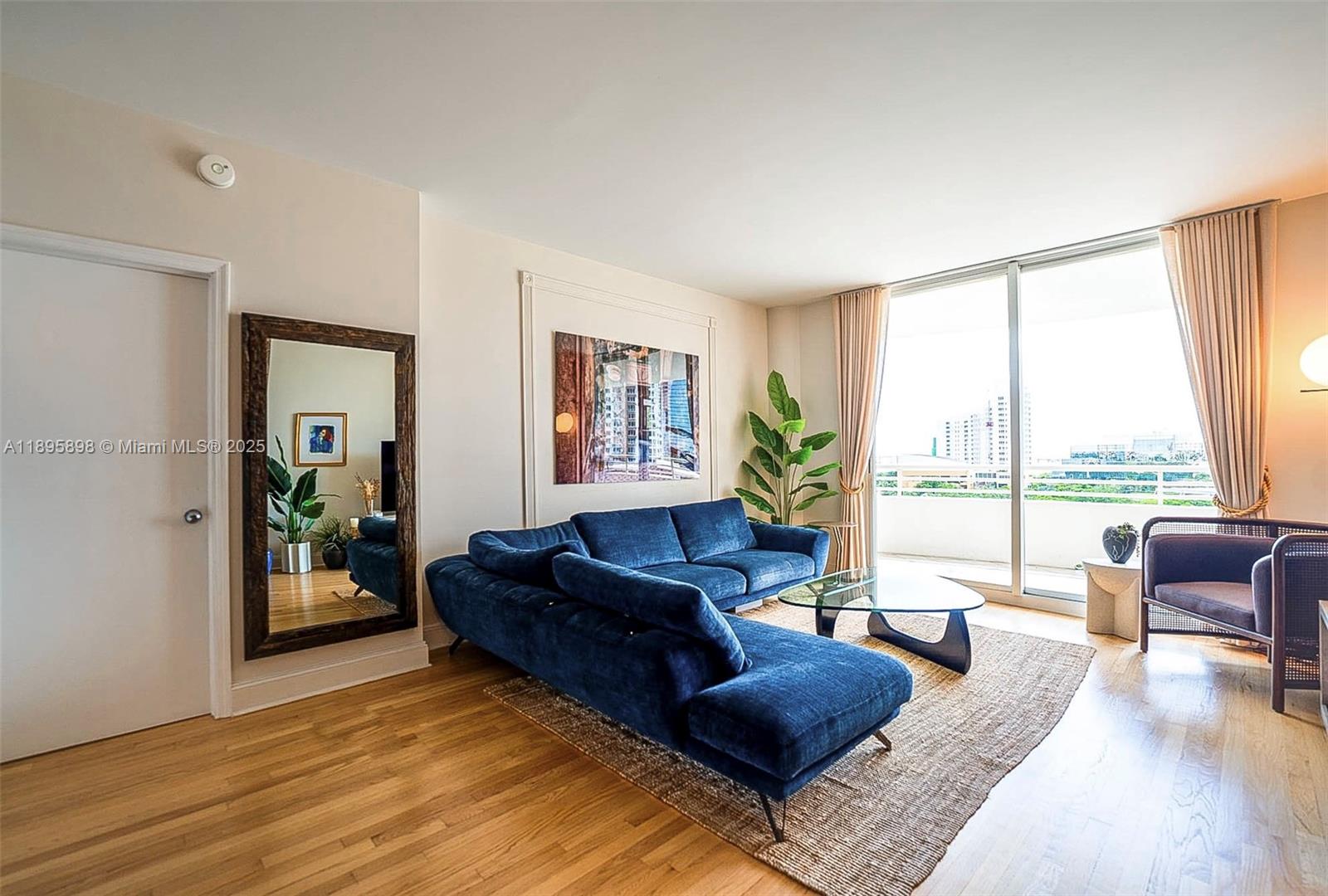 888 Brickell Key Drive, Unit 903 Miami, FL 33131 - Photo 4 of 38 a living room with furniture and a large window