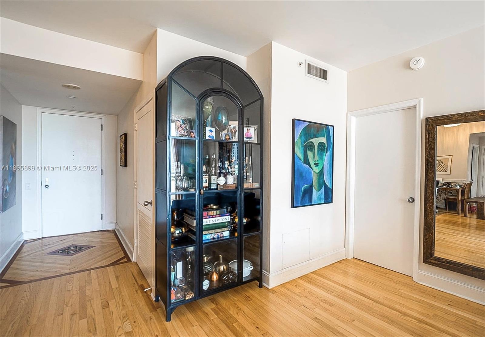 888 Brickell Key Drive, Unit 903 Miami, FL 33131 - Photo 6 of 38 a view of room with window and wooden floor