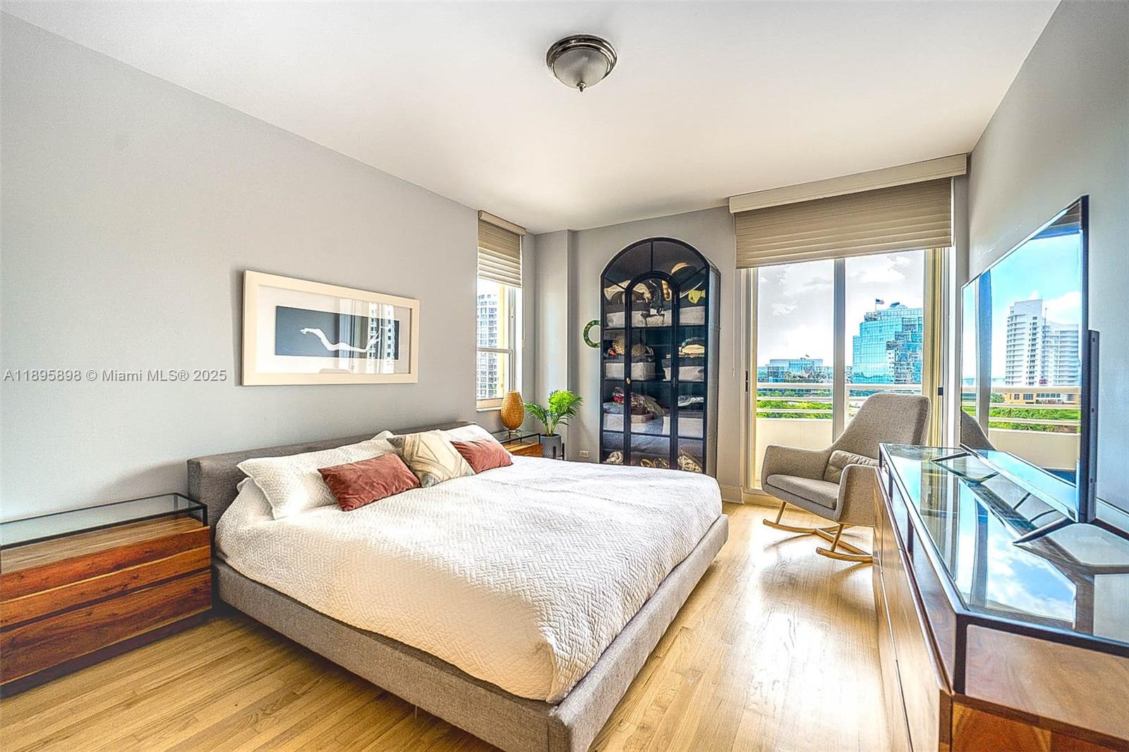 888 Brickell Key Drive, Unit 903 Miami, FL 33131 - Photo 9 of 38 a bedroom with a large bed and a large window